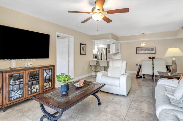 tiled living room with ceiling fan