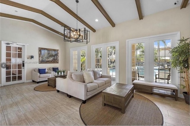 living room with french doors, high vaulted ceiling, a notable chandelier, and plenty of natural light