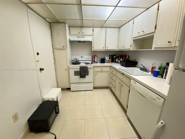 kitchen featuring white appliances, light tile patterned floors, sink, and a drop ceiling