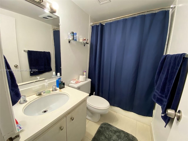 bathroom with vanity, toilet, walk in shower, and tile patterned flooring