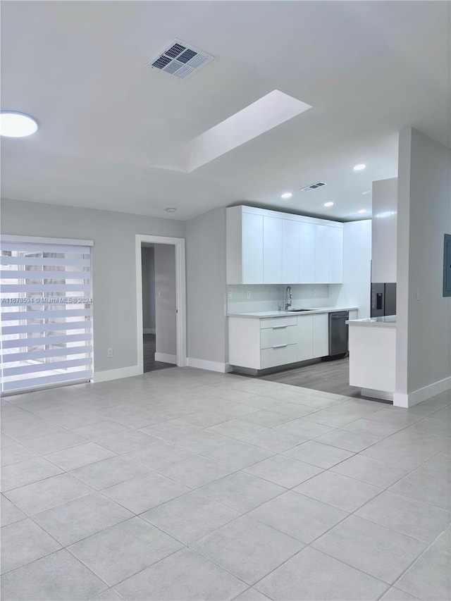 unfurnished living room with sink and light tile patterned floors