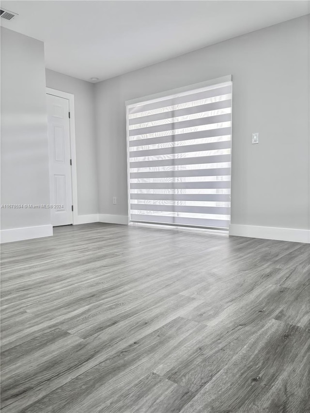 spare room featuring wood-type flooring