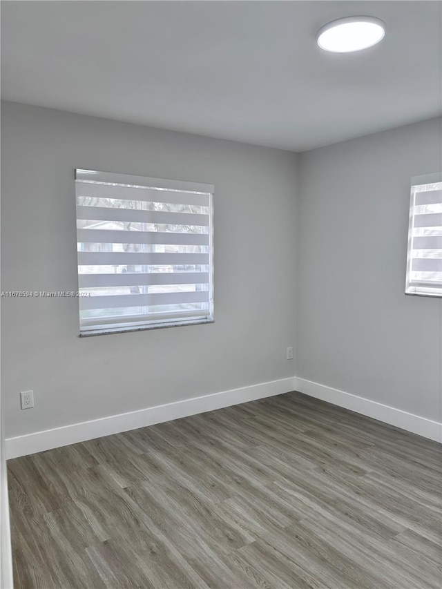 unfurnished room featuring dark hardwood / wood-style floors