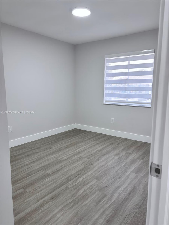 unfurnished room featuring hardwood / wood-style floors