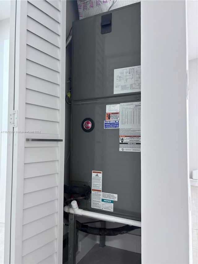 utility room featuring heating unit