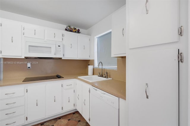 kitchen featuring sink, white cabinets, and white appliances