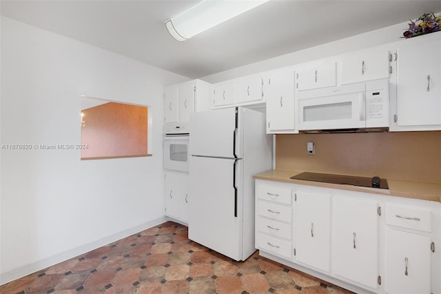 kitchen featuring white cabinetry and white appliances