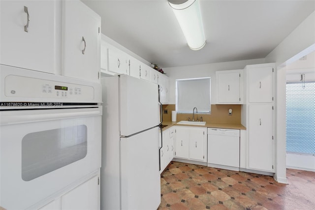 kitchen featuring white cabinets, sink, and white appliances