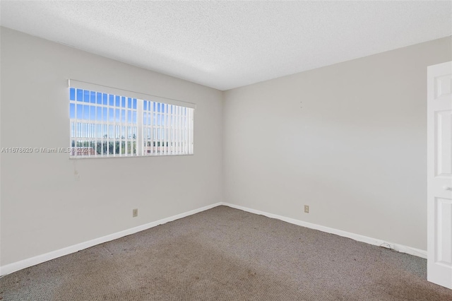 unfurnished room featuring a textured ceiling and carpet floors