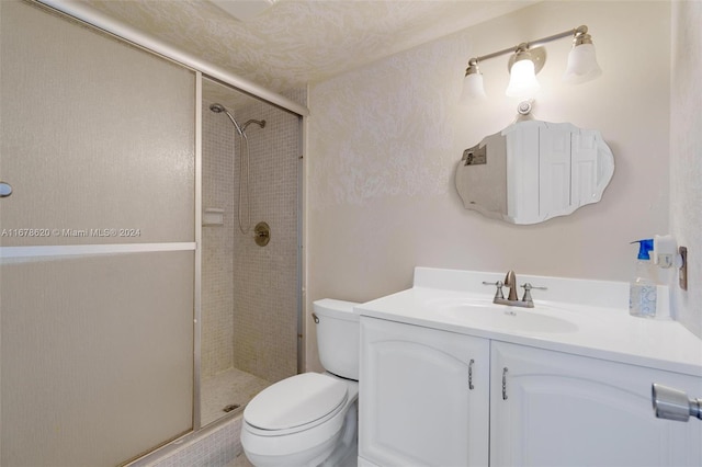 bathroom featuring vanity, toilet, and an enclosed shower