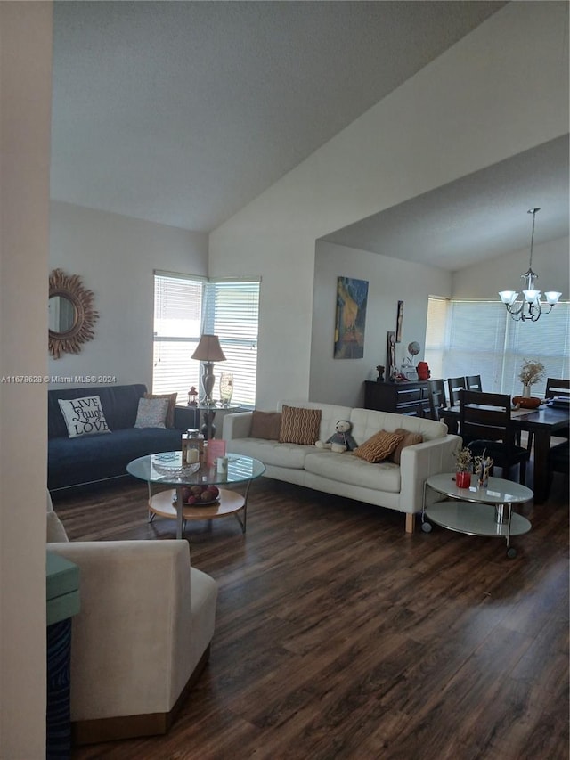 living room with vaulted ceiling, an inviting chandelier, and dark hardwood / wood-style flooring