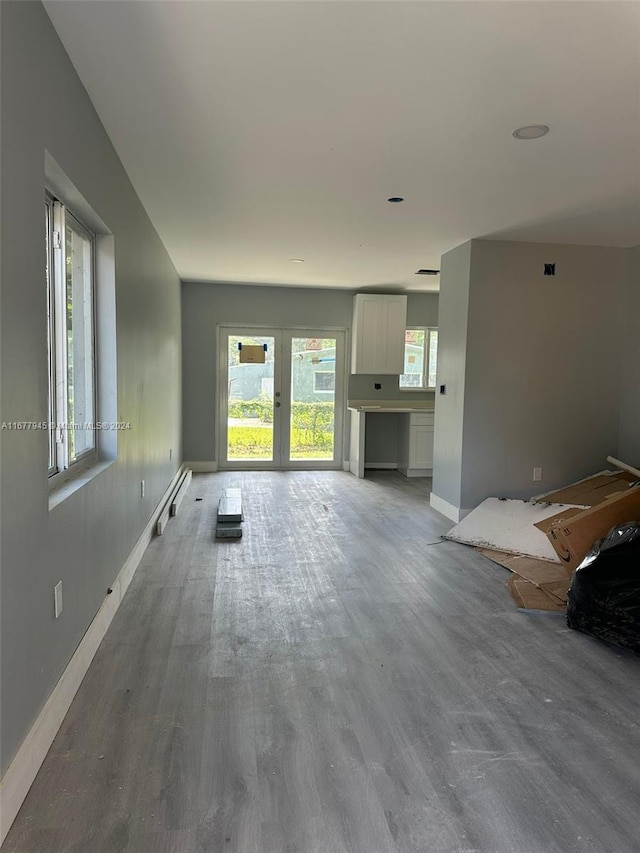 unfurnished living room with french doors and hardwood / wood-style floors