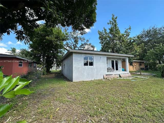 rear view of house with a lawn