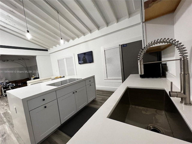 kitchen with dark hardwood / wood-style flooring, pendant lighting, gray cabinets, black electric stovetop, and lofted ceiling with beams