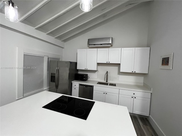 kitchen featuring sink, appliances with stainless steel finishes, lofted ceiling with beams, and white cabinets