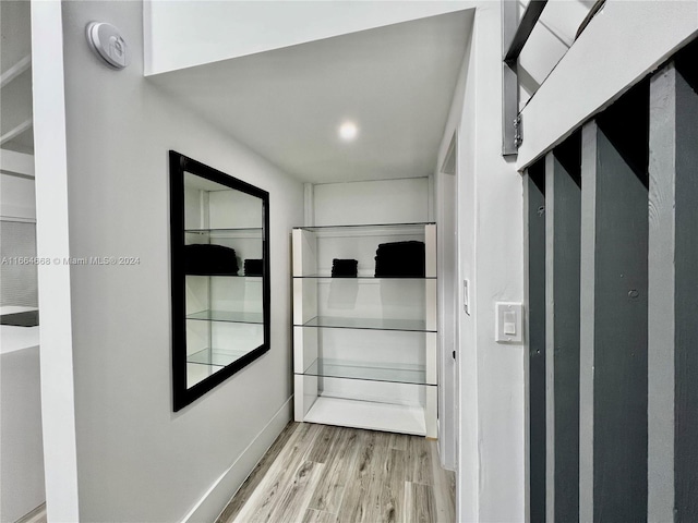 corridor with light hardwood / wood-style floors