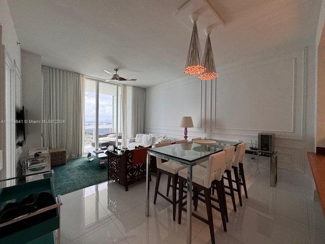 dining space featuring ceiling fan and ornamental molding