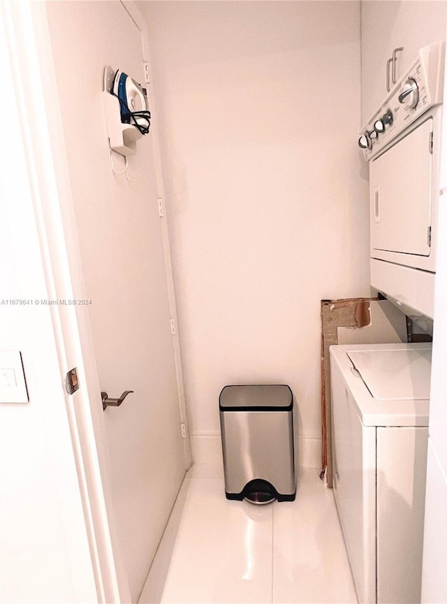 laundry area featuring stacked washer and clothes dryer