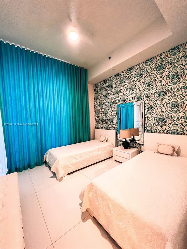 tiled bedroom with a textured ceiling and ceiling fan