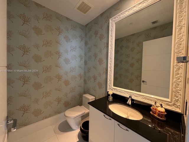 bathroom with vanity, toilet, and tile patterned floors