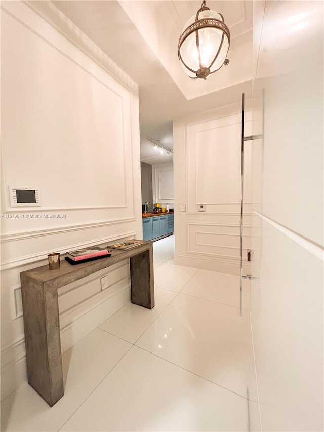 hall with sink and light tile patterned floors