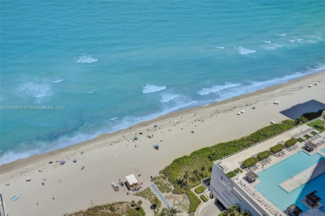 bird's eye view with a water view and a beach view