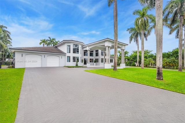 view of front of house featuring a front yard and a garage