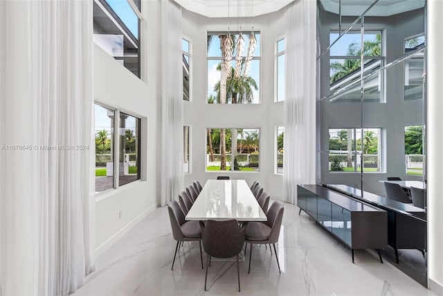 dining area featuring a towering ceiling