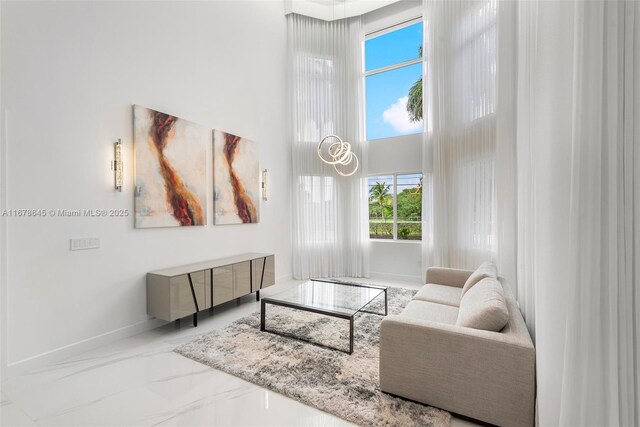 living room with a wealth of natural light and a high ceiling