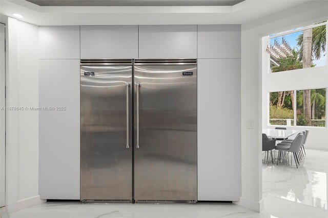 kitchen featuring gray cabinets, high end stove, and a large island