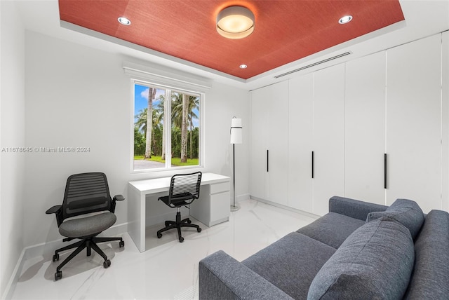 office featuring a tray ceiling