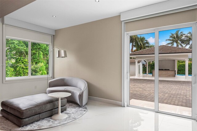 sitting room featuring a healthy amount of sunlight and tile patterned floors