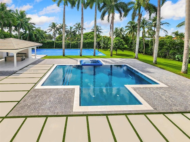 view of swimming pool featuring a patio and a lawn