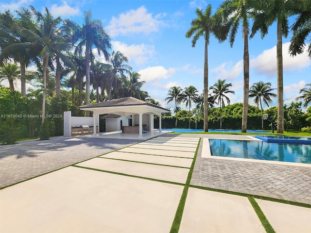 view of swimming pool featuring a patio and a gazebo