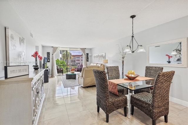 dining space featuring a notable chandelier, a textured ceiling, and light tile patterned floors