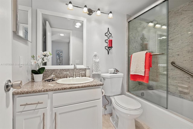 full bathroom with vanity, toilet, tile patterned floors, and shower / bath combination with glass door