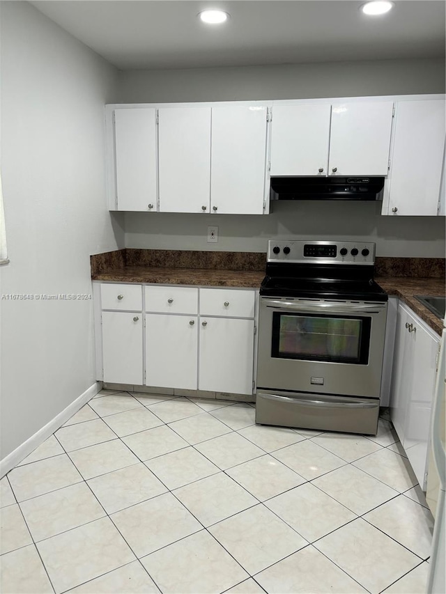 kitchen featuring white cabinetry, stainless steel electric range oven, and light tile patterned floors