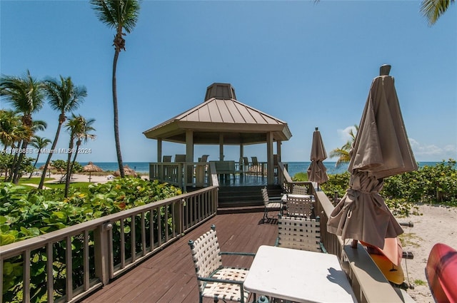 wooden terrace featuring a gazebo and a water view