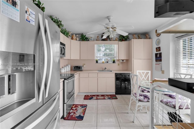 kitchen featuring light tile patterned floors, appliances with stainless steel finishes, sink, and ceiling fan