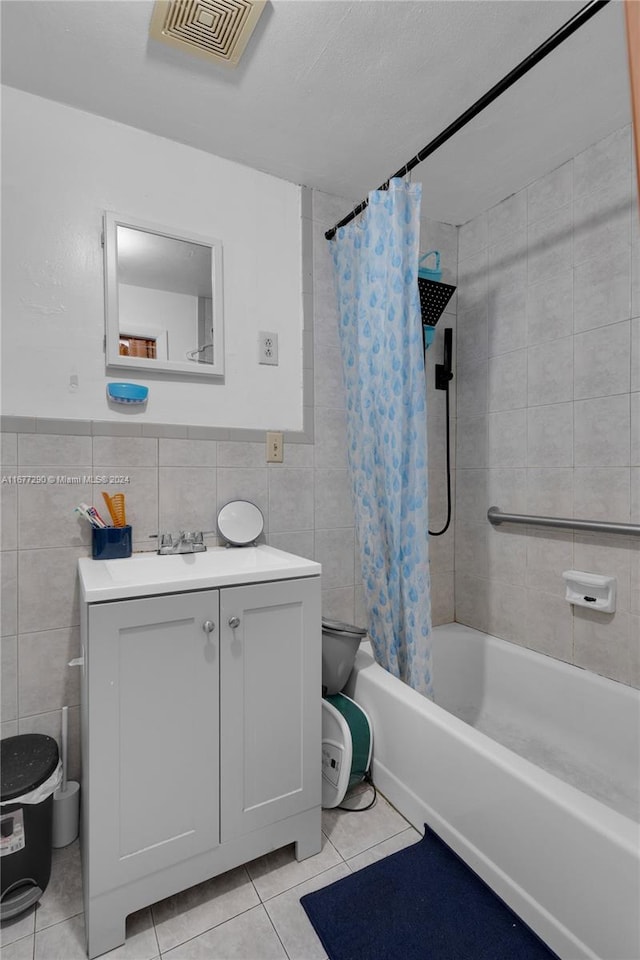 full bathroom with vanity, tile walls, shower / bath combo, and tile patterned flooring