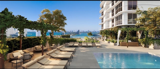 view of swimming pool with a patio, an outdoor living space, and a water view