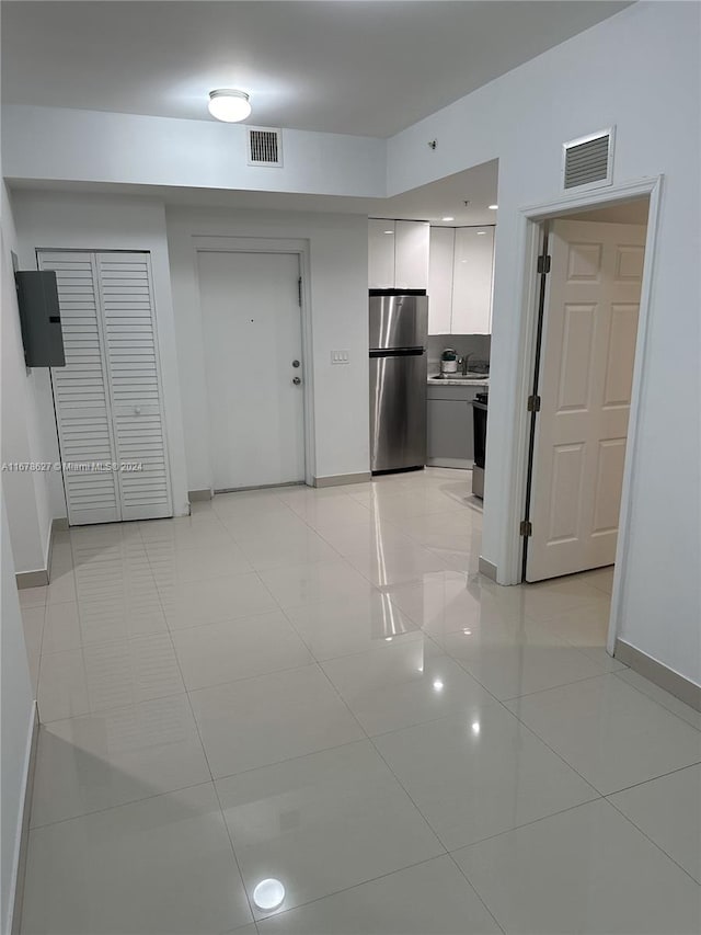 kitchen featuring stainless steel fridge and light tile patterned floors