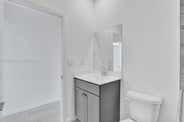 bathroom with toilet and vanity