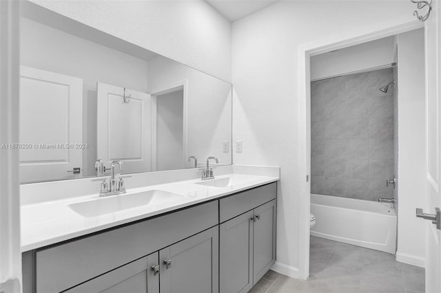 full bathroom featuring vanity, tiled shower / bath, toilet, and tile patterned floors