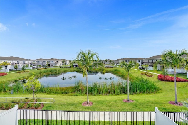 view of community featuring a water view and a lawn