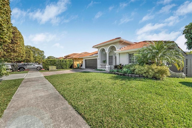 mediterranean / spanish-style house featuring a front lawn and a garage