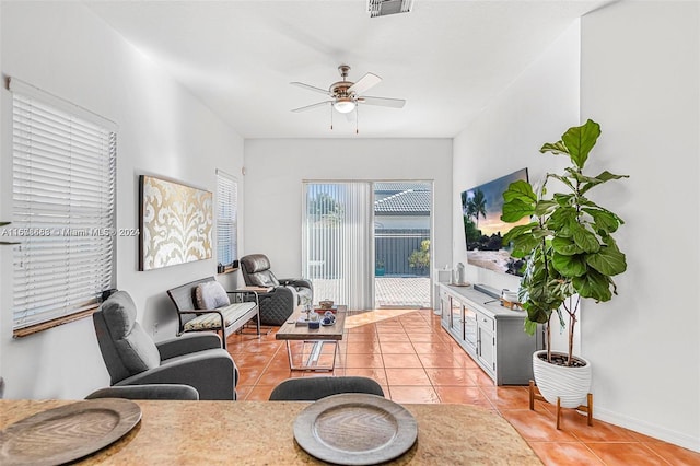 tiled living room featuring ceiling fan