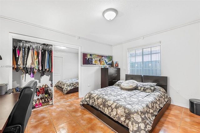 tiled bedroom with a closet