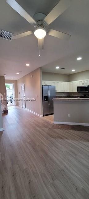 unfurnished living room with light hardwood / wood-style floors and ceiling fan