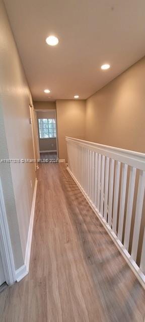 hallway with hardwood / wood-style floors